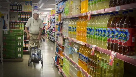 Shoppers peruse prices at a supermarket 