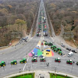 Los tractores están alineados en el bulevar "Strasse des 17 Juni", hacia la Puerta de Brandenburgo en Berlín, mientras los agricultores alemanes se manifiestan contra la prevista abolición de los subsidios al diésel agrícola. | Foto:JOHN MACDOUGALL / AFP