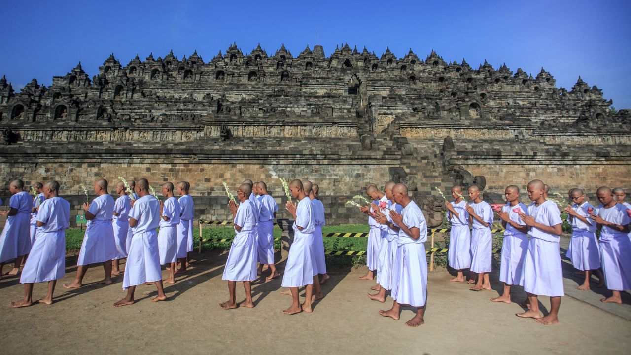 Los candidatos a monje budista meditan y caminan descalzos tres veces alrededor del templo de Borobudur durante el ritual anual 'Pabbaja Samanera', un entrenamiento moral y espiritual de 12 días para futuros monjes, en Magelang, Indonesia. | Foto:DEVI RAHMAN / AFP