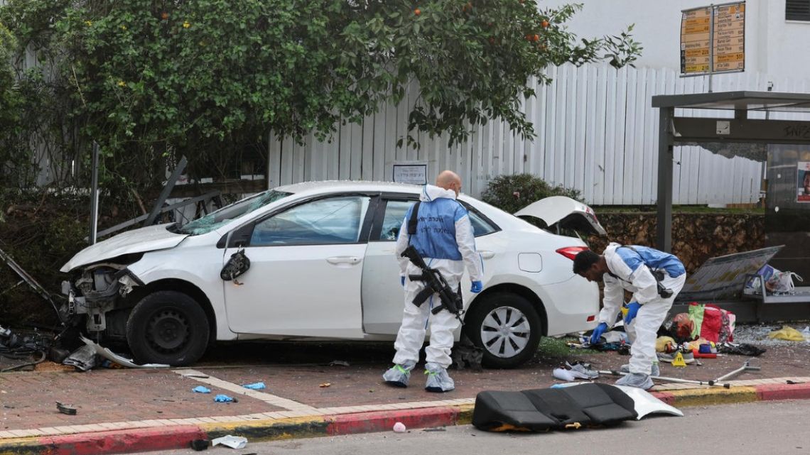 Israeli police personnel inspect a damaged car following a suspected ramming attack on Monday.