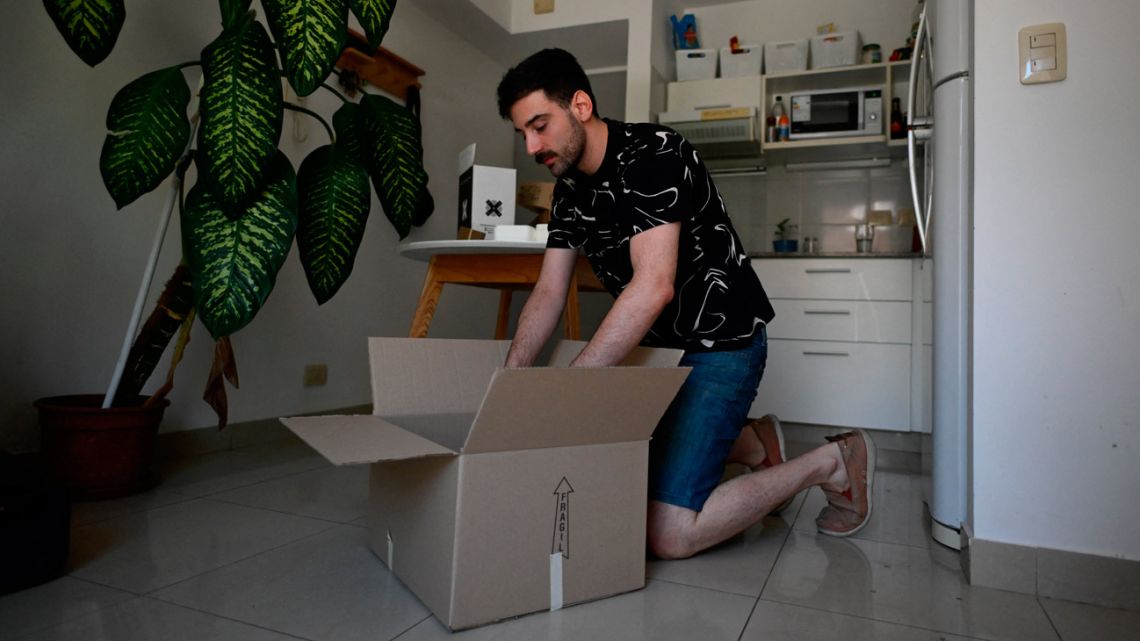 Tomás Sislián packs his belongings as he prepares to move out a the rented apartment, pushed by the real-estate crisis, in Buenos Aires, on January 8, 2024.