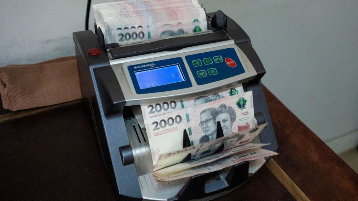 Peso banknotes are counted at a currency exchange house in Buenos Aires.
