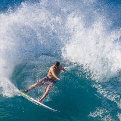 El surfista estadounidense Crosby Colapinto monta una ola antes de los eventos de surf del campeonato de la World Surf League (WSL) en la costa norte de Oahu, Hawaii. | Foto:Brian Bielmann / AFP