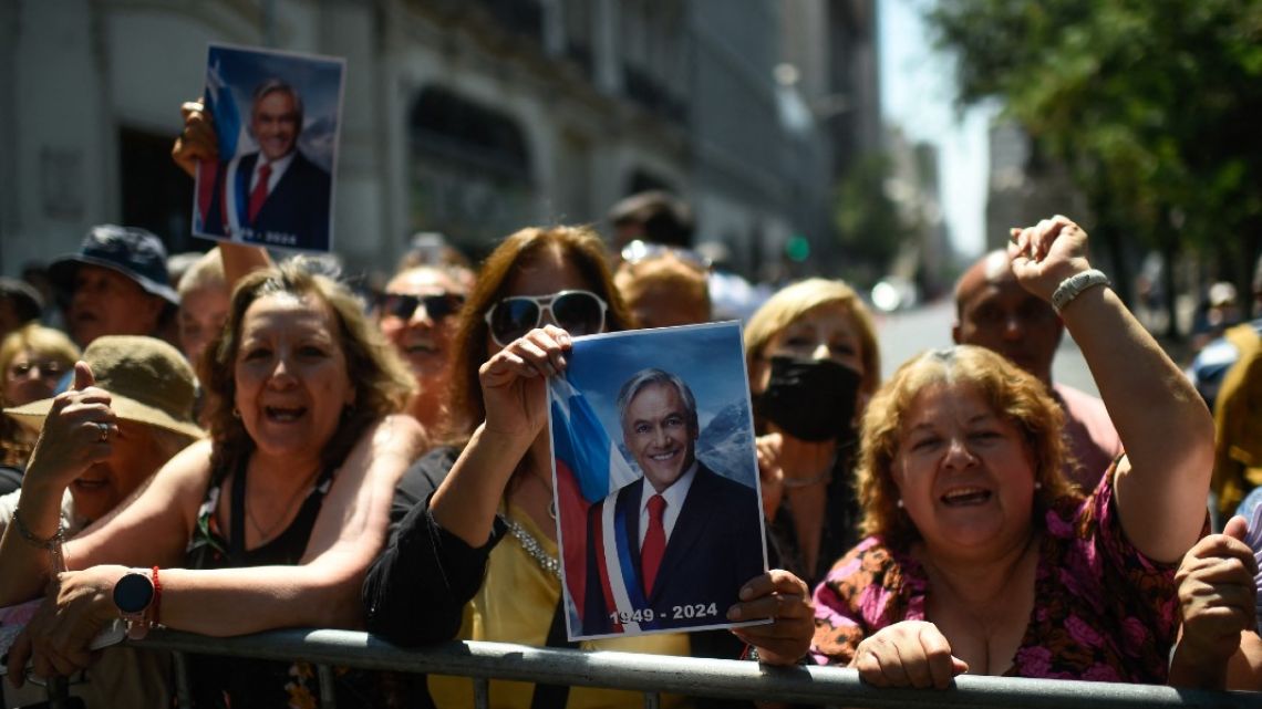 Supporters of former Chilean President Sebastian Piñera gather outside the National Congress in Santiago on February 7, 2024. 