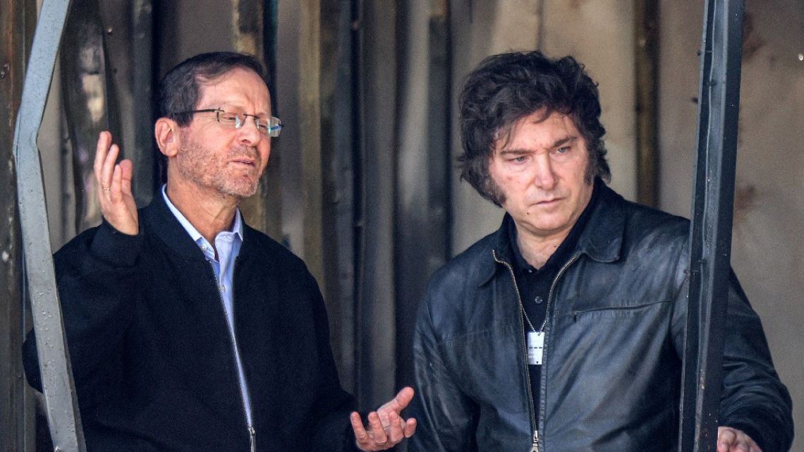 President Javier Milei (R) is toured around Kibbutz Nir Oz -- one the places targeted by Palestinian militants from the Gaza Strip during the October 7, 2023 attacks -- by Israel's President Isaac Herzog in southern Israel on February 8, 2024.