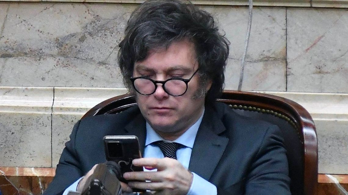 Javier Milei using his mobile phone.