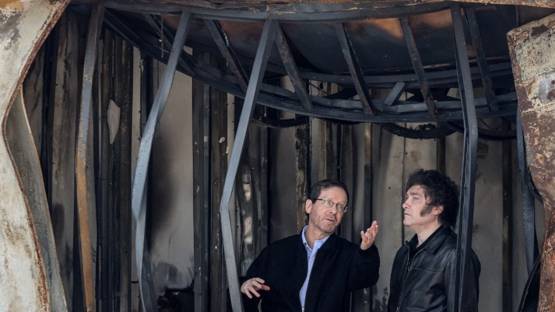 President Javier Milei (right) tours around Kibbutz Nir Oz – one the places targeted by Palestinian militants from the Gaza Strip during the October 7, 2023 attacks – by Israel's President Isaac Herzog in southern Israel on February 8, 2024. 
