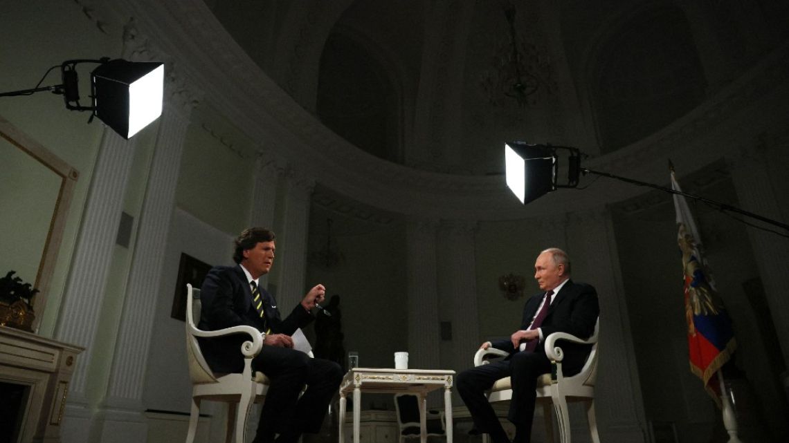 In this pool photograph distributed by Russian state agency Sputnik, Russia's President Vladimir Putin gives an interview to US talk show host Tucker Carlson at the Kremlin in Moscow 