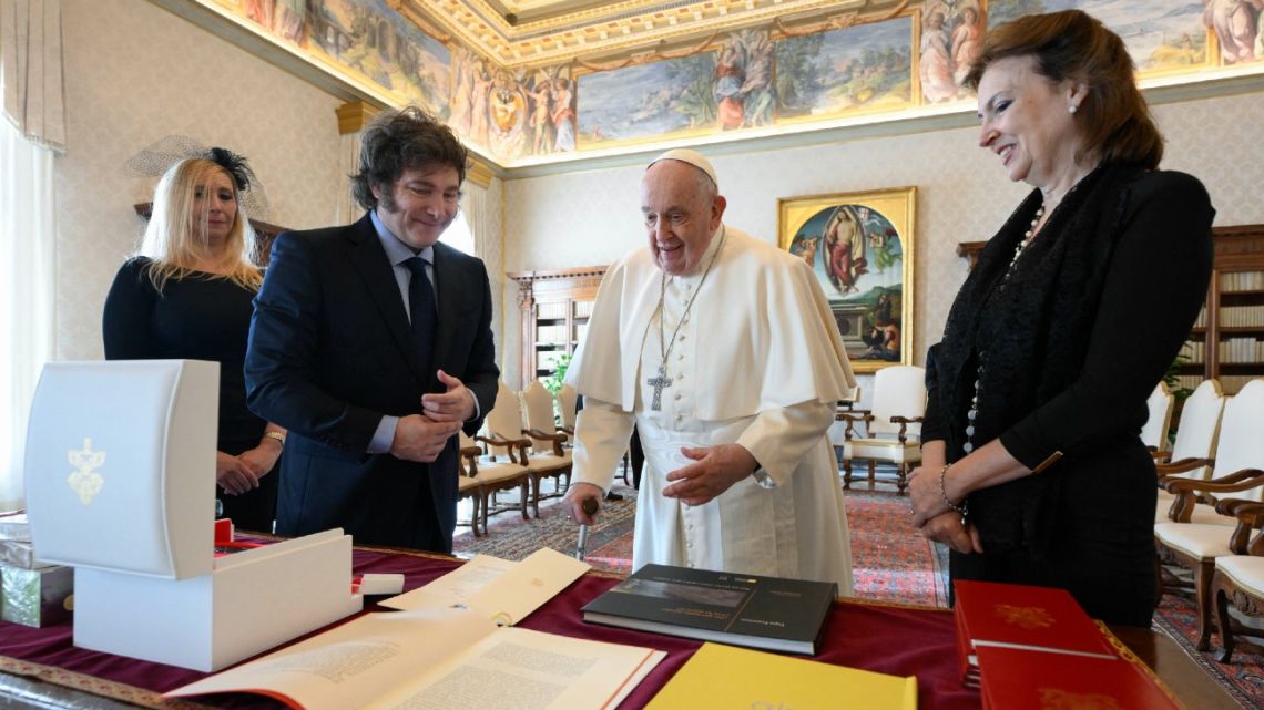 Pope Francis exchanges gifts with President Javier Milei during a private audience at the Vatican; The president's sister, Secretary General to the Presidency Karina Milei, and Foreign Minister Diana Mondino, watch on.