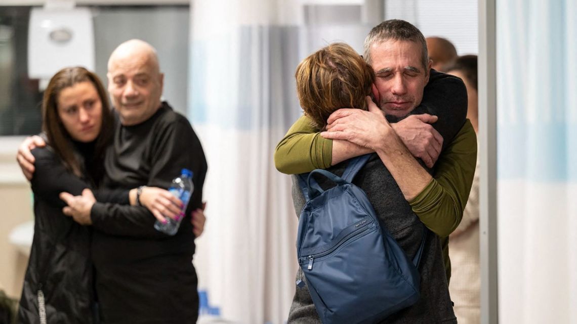 This handout picture released by the Israeli Army on February 12, 2024, shows rescued Israeli-Argentine hostage Fernando Simon Marman (right) being reunited with his family at the Tel Hashomer Hospital in Ramat Gan, on the outskirts of Tel Aviv. 