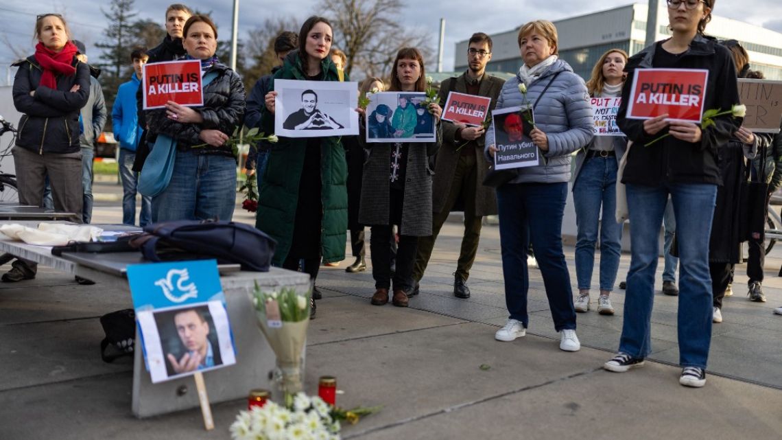 Protestors hold placards reading "Putin is a killer" during a demonstration outside of the United Nations' Office in Geneva on February 16, 2024, following the news of Russian opposition leader Alexei Navalny's death at the Arctic prison.