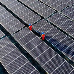 Trabajadores inspeccionando paneles solares en el tejado de una planta de energía en Fuzhou, en la provincia de Fujian. Foto de AFP | Foto:AFP
