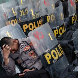 Un policía descansa entre los escudos durante una manifestación que exige la destitución del presidente de Indonesia, Joko Widodo. Foto de Yasuyoshi CHIBA / AFP | Foto:AFP