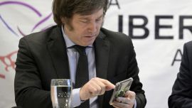 Javier Milei uses his cell phone during a press conference in Buenos Aires on October 11, 2023.