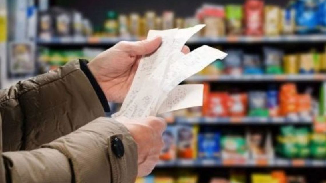 A shopper checks his bill at a supermarket in Buenos Aires.