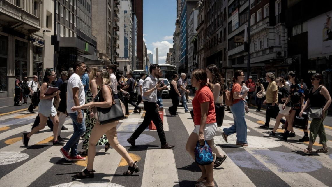 Pedestrians cross Corrientes Avenue in Buenos Aires, Argentina, on Wednesday, January 10, 2024.