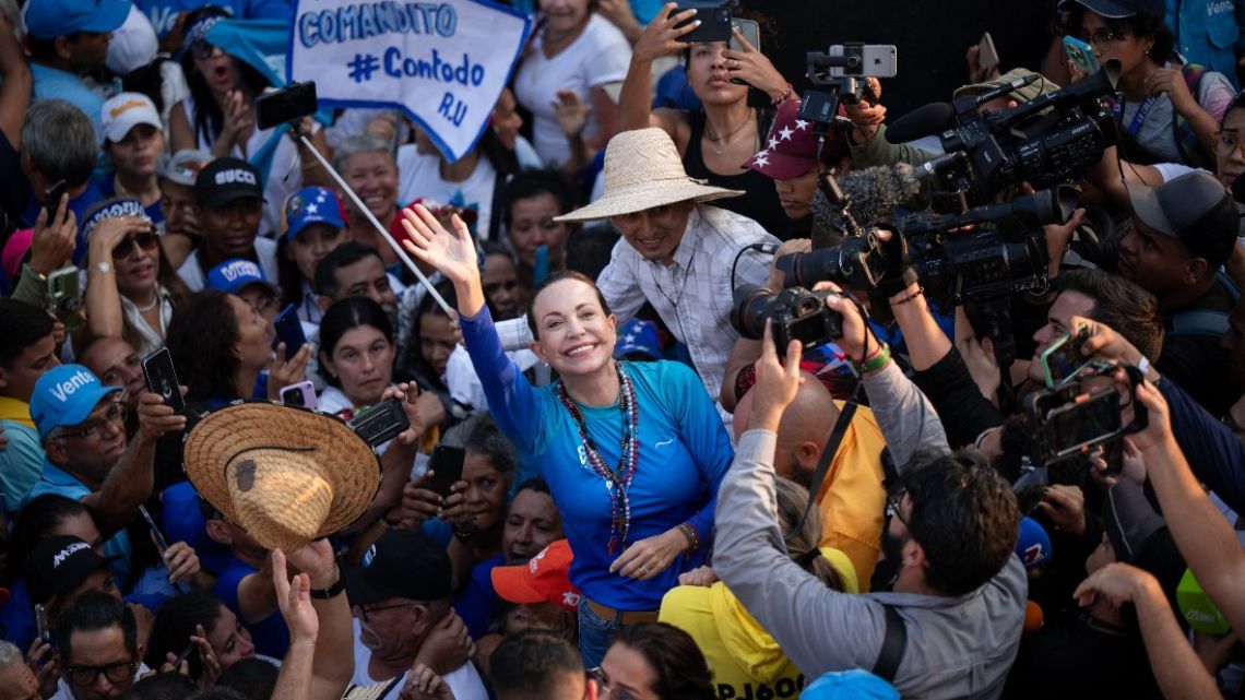 Venezuelan opposition leader, Maria Corina Machado, greets supporters during a rally in Valencia, Carabobo State, Venezuela
