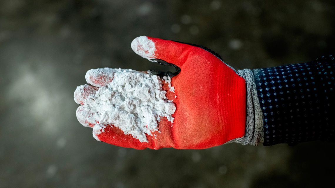 A worker holds lithium at SQM’s plant in Antofagasta.