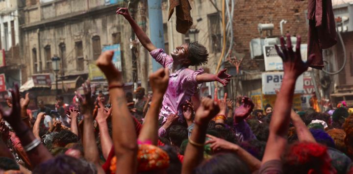La gente participa en las celebraciones de Holi, el festival hindú de colores de primavera, en Varanasi, India.