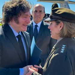 Argentina's President Javier Milei shakes hands with Commander of the United States Southern Command, General Laura Richardson, during the signing of an agreement by which an aircraft was incorporated into the Argentine Air Force on April 5, 2024, at the military area of the Aeroparque Jorge Newbery airport in Buenos Aires.