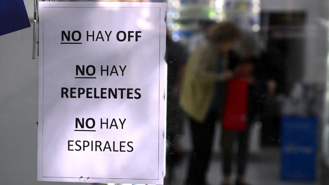 A sign reading 'No OFF, No Repellents, No Spirals Available' is displayed on the window of a pharmacy in Buenos Aires, Argentina, on April 5, 2024.
