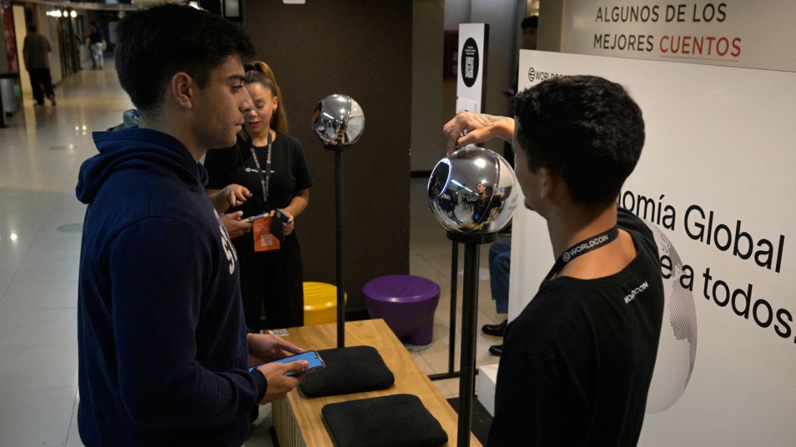 A man has his iris scanned with an orb, a biometric data scanning device, in exchange for the Worldcoin cryptocurrency in Buenos Aires on March 22, 2024. 