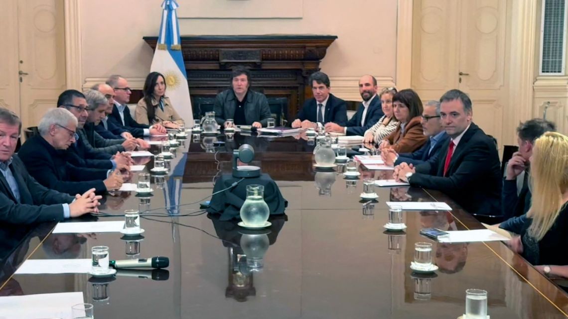 This handout picture released by the Presidency shows President Javier Milei meeting with Israeli Ambassador to Argentina Eyal Sela, Vice-President Victoria Villarruel, Cabinet Chief Nicolás Posse, and other members of his government at the Casa Rosada presidential palace in Buenos Aires on April 14, 2024. 