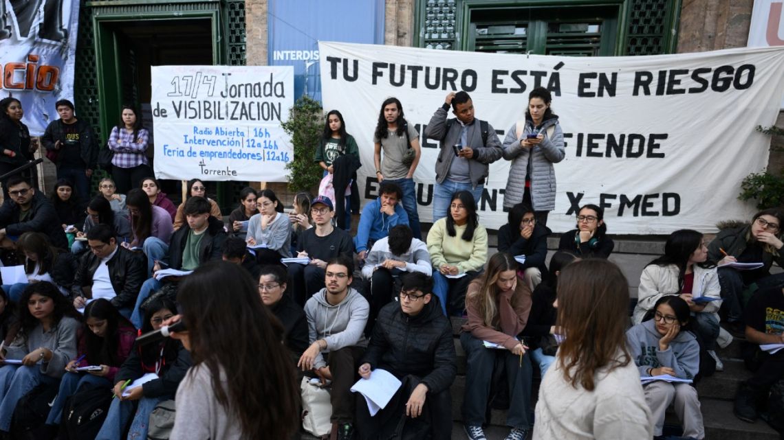Medicine students of the University of Buenos Aires (UBA) take an open lecture at the entrance of the university to protest against the recent economic measures introduced by the government of President Javier Milei in Buenos Aires, on April 17, 2024. 