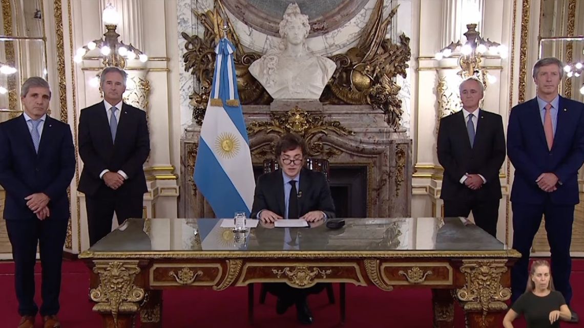 President Javier Milei, flanked by four government officials, addresses Argentina in a prime-time 'Cadena Nacional' nationwide brodcast.