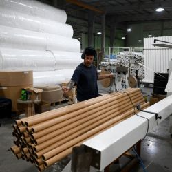 A worker organises cardboard tubes at the Papelera Rosato factory in Berazategui, Buenos Aires Province, on April 15, 2024.