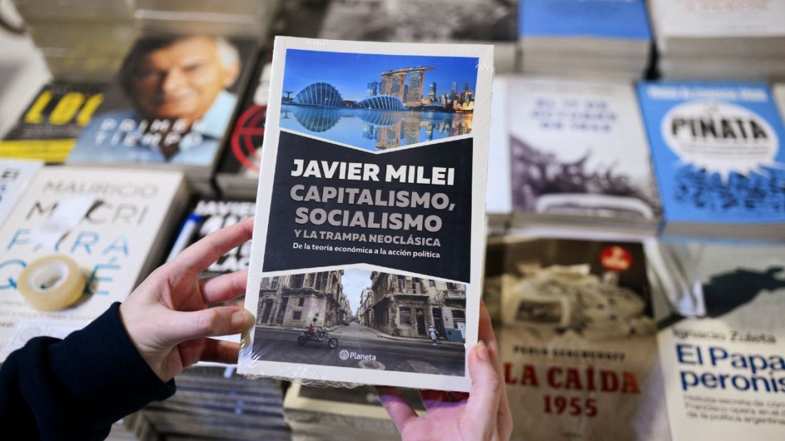 A woman holds a copy of the President Javier Milei's latest book at the 48th Buenos Aires International Book Fair on April 25, 2024. 