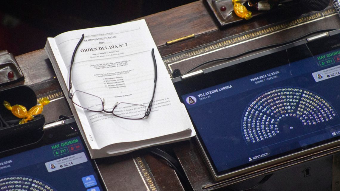 A view of a copy of a reform bill that President Javier Milei is trying to pass after withdrawing hundreds of articles from an ambitious earlier version that failed in parliament in February 2024 during its debate by the Chamber of Deputies at the National Congress in Buenos Aires on April 30, 2024. 