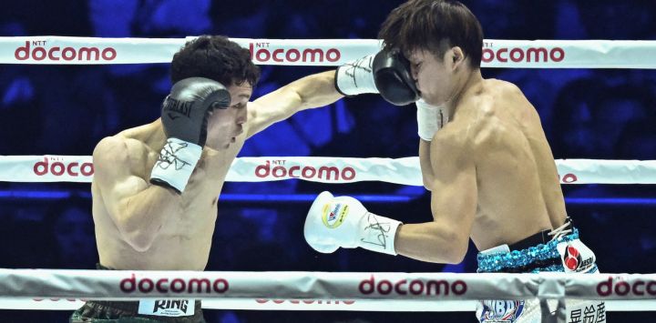 El japonés Seigo Yuri Akui lucha contra el japonés Taku Kuwahara durante su combate de boxeo por el título de peso mosca de la AMB en el Tokyo Dome de Tokio.