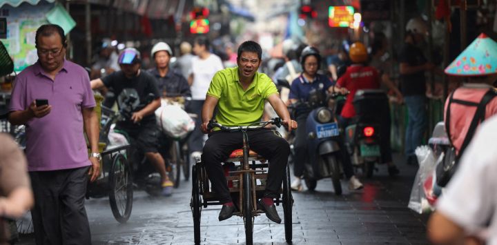 Un hombre circula en un triciclo en un mercado en Haikou, en la provincia de Hainan, en el sur de China.