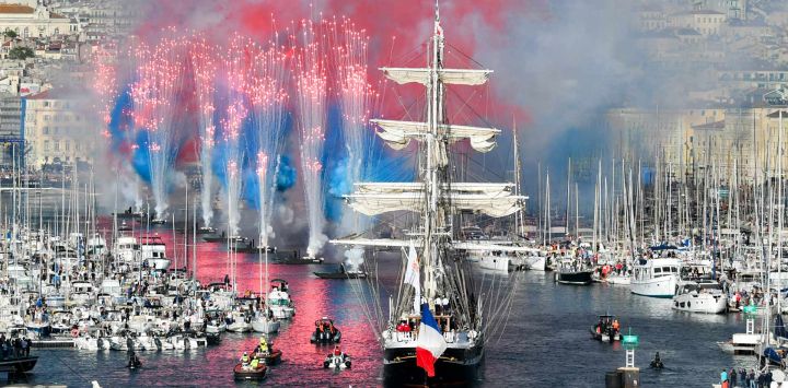 Los fuegos artificiales estallan cuando la barca francesa de tres mástiles Belem del siglo XIX llega al Vieux-Port (Puerto Viejo) durante la ceremonia de llegada de la Llama Olímpica, antes de los Juegos Olímpicos y Paralímpicos de París 2024, en Marsella, sureste de Francia.