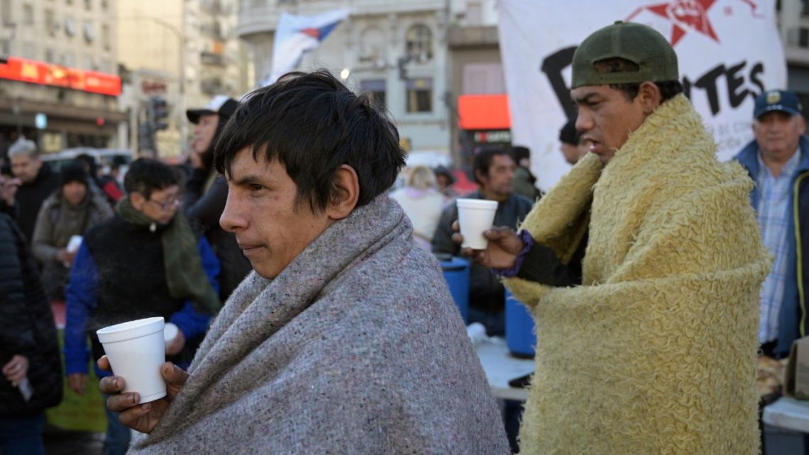 Homeless people have a free hot breakfast at the Plaza de la República square in Buenos Aires, on May 14, 2024. 