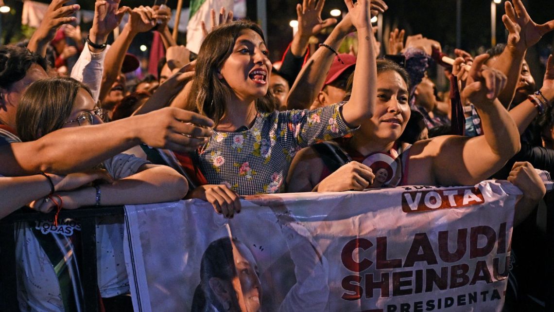 Supporters of Mexico's presidential candidate for the Morena party, Claudia Sheinbaum, wait for her at a hotel on election day in Mexico City on June 2, 2024. Claudia Sheinbaum was set to be elected Mexico's first woman president, exit polls showed, a milestone in a country with a history of gender-based violence. 