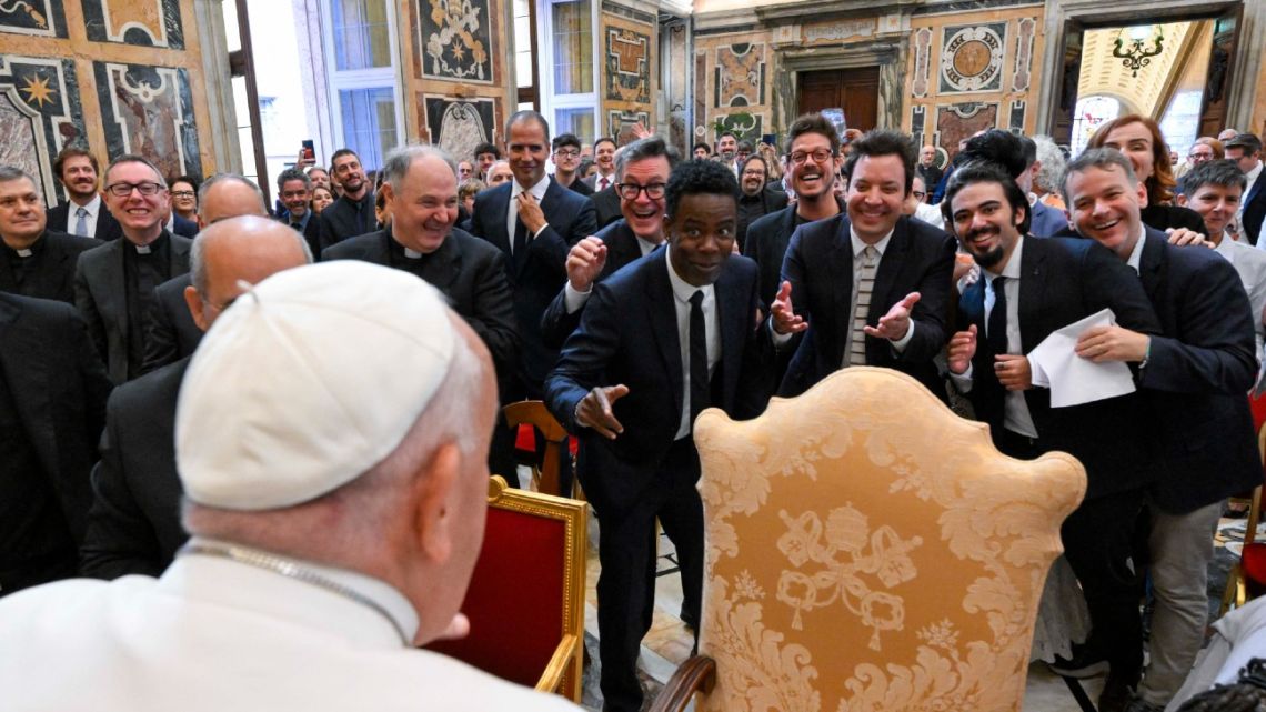 This photo taken and handout on June 14, 2024 by The Vatican Media shows US actors Chris Rock, Jimmy Fallon and Pope Francis during an audience with comedians in The Vatican. 