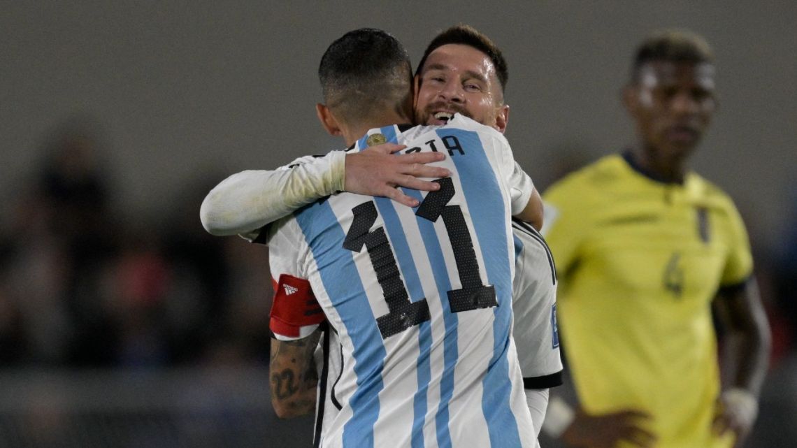 Argentina's forward Lionel Messi gives the captain's armband to teammate Ángel Di María.