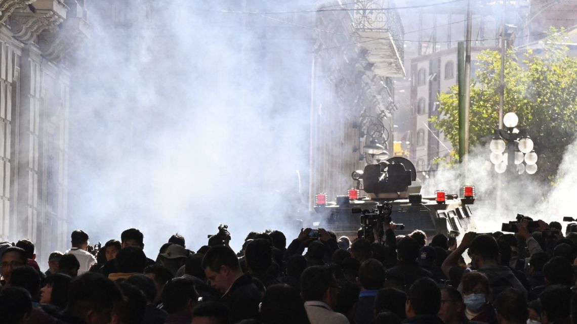 Military troops in armored vehicles fire tear gas at people outside the Quemado Palace at Plaza Murillo in La Paz on June 26, 2024.