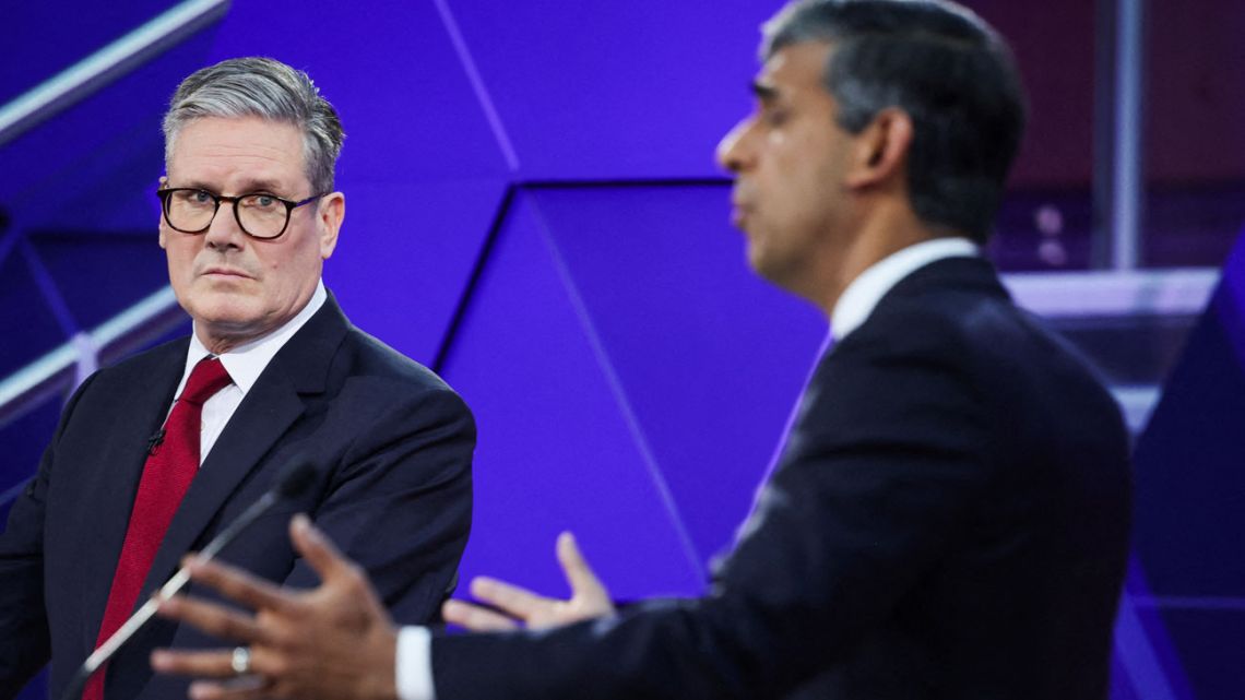 Britain's main opposition Labour Party leader Keir Starmer reacts as Britain's Prime Minister and Conservative Party leader Rishi Sunak speaks during a live TV debate, hosted by The BBC, in Nottingham, on June 26, 2024, in the build-up to the UK general election on July 4. 