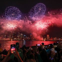 La gente se reúne cerca del río Hudson durante el espectáculo anual de fuegos artificiales del Día de la Independencia de Macy's, visto desde Hoboken, Nueva Jersey. | Foto:KENA BETANCUR / AFP