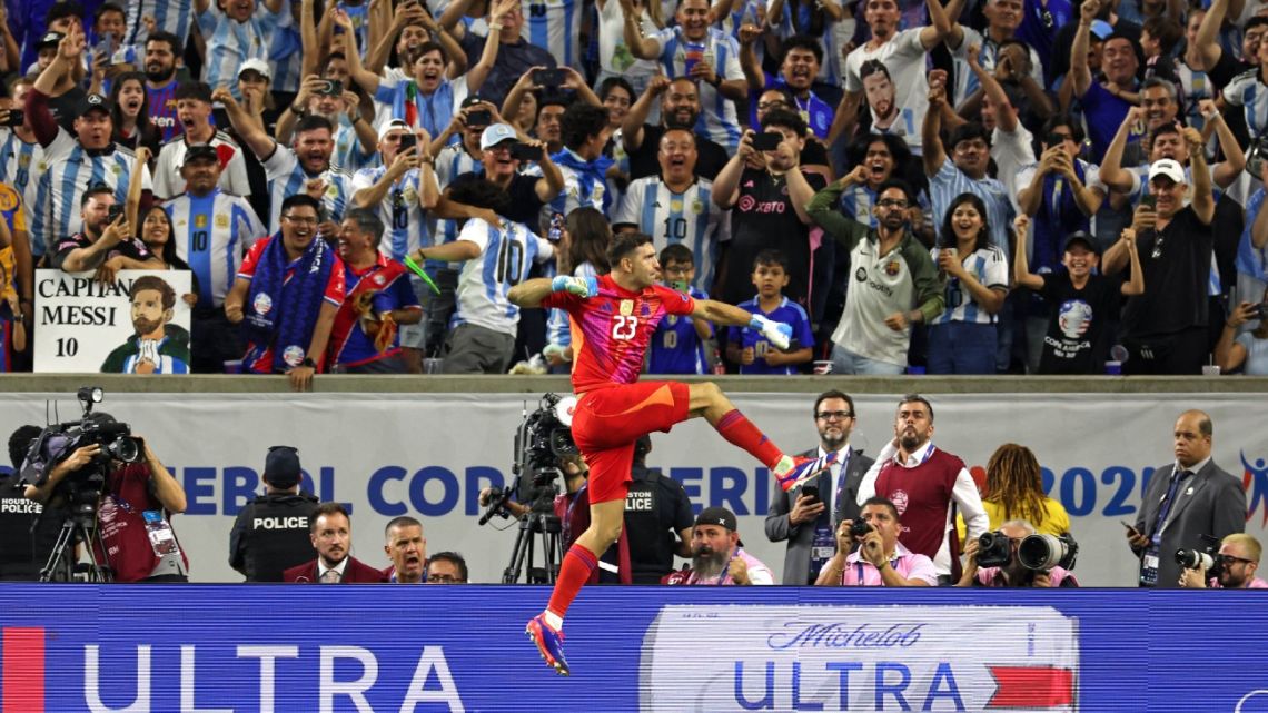 Argentina's goalkeeper #23 Emiliano Martínez celebrates after saving a goal during a penalty shoot out during the Conmebol 2024 Copa America tournament quarter-final football match between Argentina and Ecuador at NRG Stadium in Houston, Texas, on July 4, 2024. 