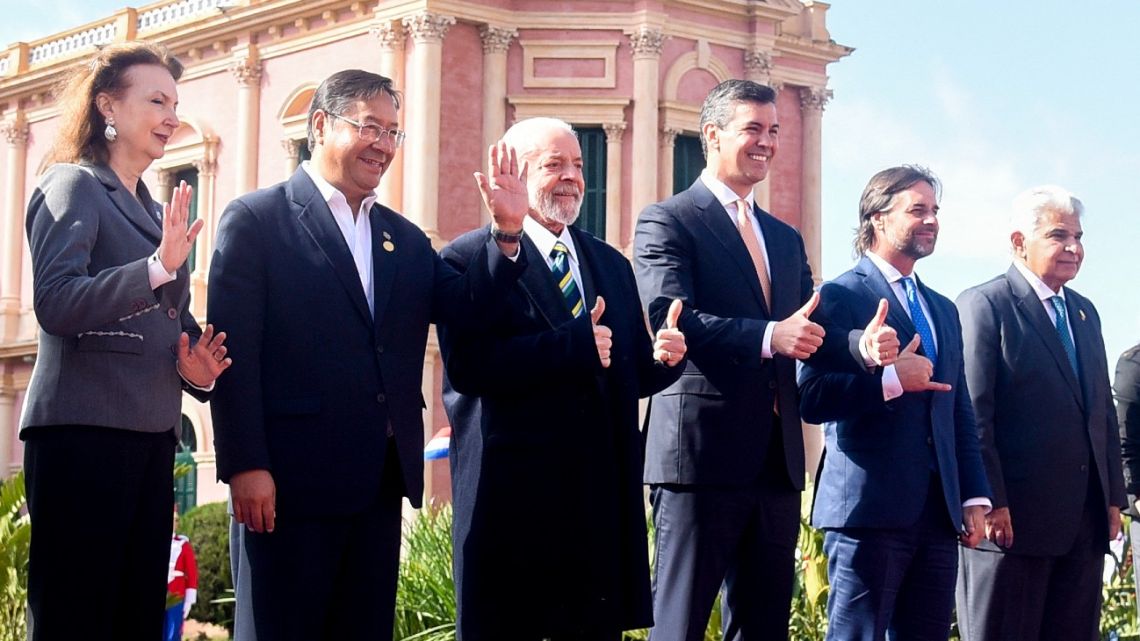 Left to right: Argentina's Foreign Minister Diana Mondino, Bolivia's President Luis Arce, Brazil's President Luiz Inácio Lula da Silva, Paraguay's President Santiago Peña, Uruguay's President Luis Lacalle Pou, and Panama's President José Raúl Mulino pose for the family photo at the Palacio de López Presidential Palace during the Mercosur summit in Asuncion on July 8, 2024.