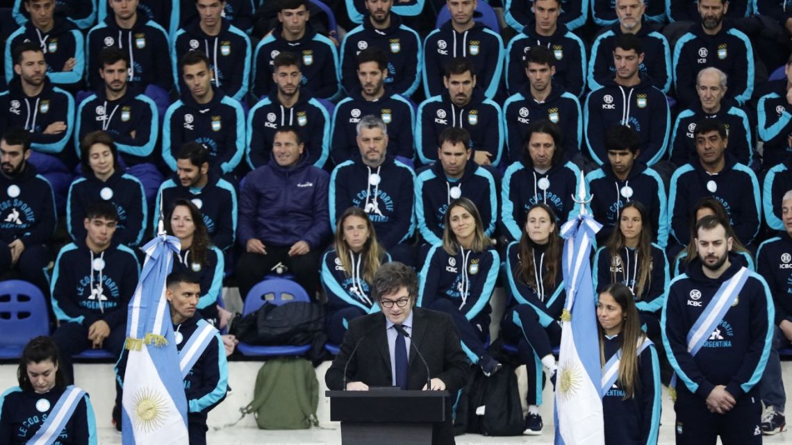 Argentinian President Javier Milei (Bottom C) gives a speech next to the olympic and paralympic flag bearers, paralympic athlete Hernan Barreto (Bottom L), and field hockey player Rocio Sanchez Moccia (Bottom R), during a ceremony with the delegation of Argentine athletes who will participate in the Paris 2024 Olympic and Paralympic Games at the National Center of High Performance Athletics (CeNARD) in Buenos Aires on July 5, 2024. 