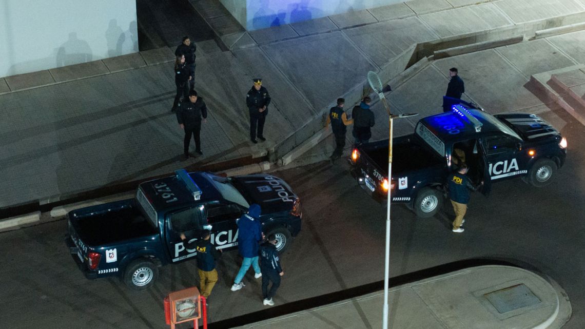 French national rugby player Hugo Auradou and French national rugby player Oscar Jegou (TOP 2nd-R) are escorted by Federal Police as they arrive at the Transitory Station for Detained and Apprehended Persons in Mendoza, Argentina, on July 11, 2024. 