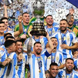 Argentina's forward #10 Lionel Messi lifts up the trophy as he celebrates winning the Conmebol 2024 Copa America tournament final football match between Argentina and Colombia at the Hard Rock Stadium, in Miami, Florida on July 14, 2024. 