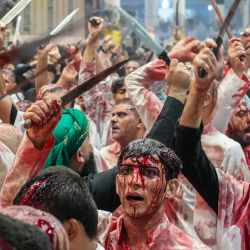 Los musulmanes chiítas participan en un ritual de flagelación de Ashura, que conmemora el asesinato en el siglo VII del nieto del profeta Mahoma, el Imam Hussein, en la ciudad santa iraquí de Nayaf. | Foto:Qassem al-Kaabi / AFP