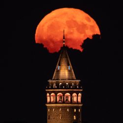 Parte de la luna llena sale detrás de la Torre de Gálata en Estambul, Turquía. | Foto:KEMAL ASLAN / AFP