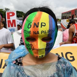 Un manifestante que marcha hacia el Congreso lleva una máscara con un lema que dice "Filipinas tiene hambre, aumenten los salarios" durante una manifestación que coincidió con el discurso sobre el estado de la nación del presidente filipino Ferdinand Marcos, en Manila. | Foto:TED ALJIBE /AFP